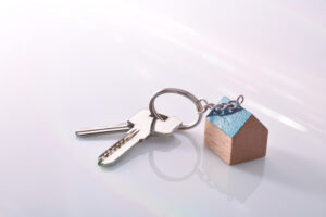 Keys with a house shaped keyring on a white