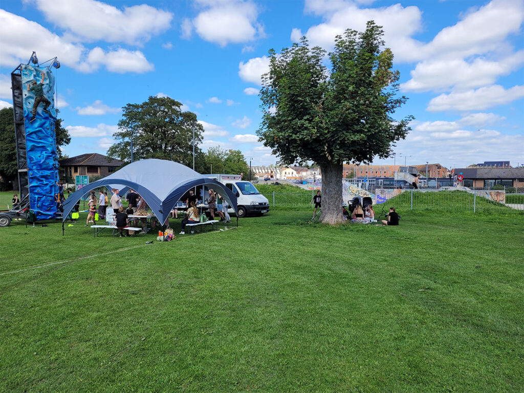 Picture of a field in Trowbridge with tent and pop up cafe event taking place