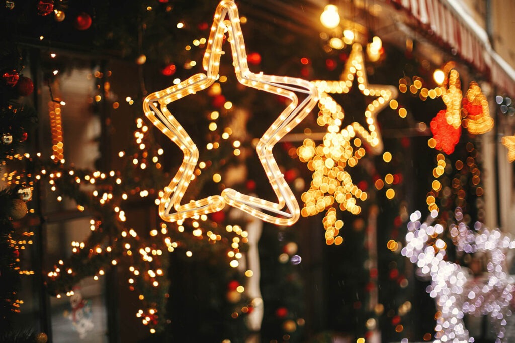 Star shaped christmas lights handing in front of a shop window