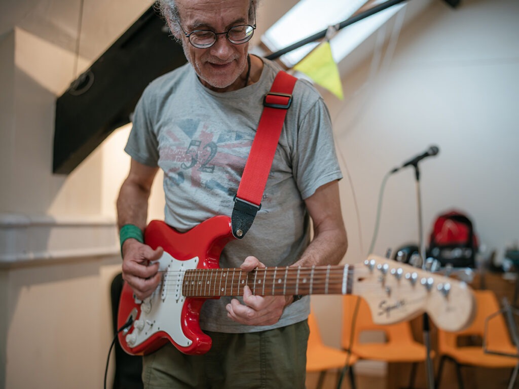 Older man playing guitar