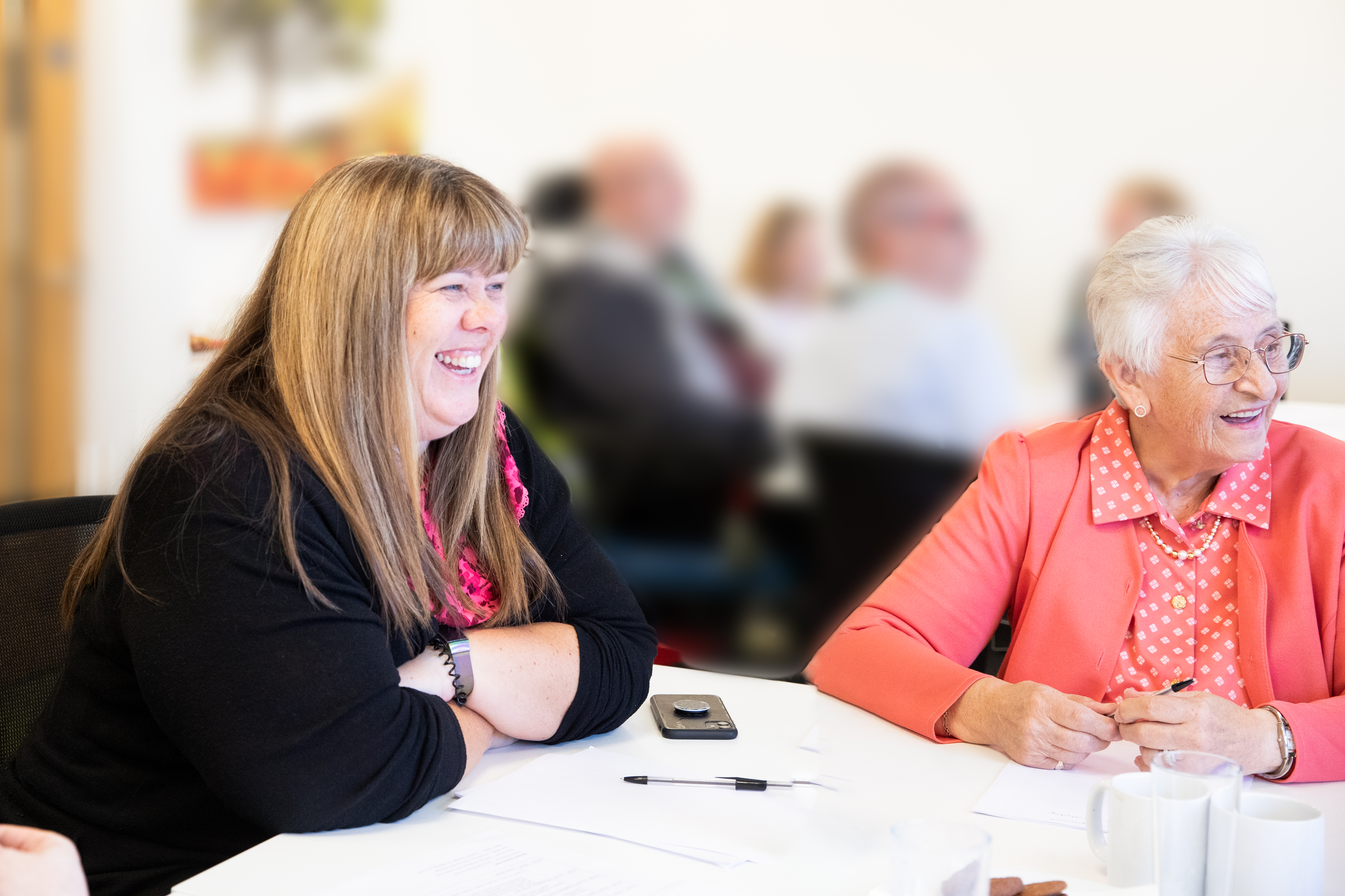 Two customer smiling and talking