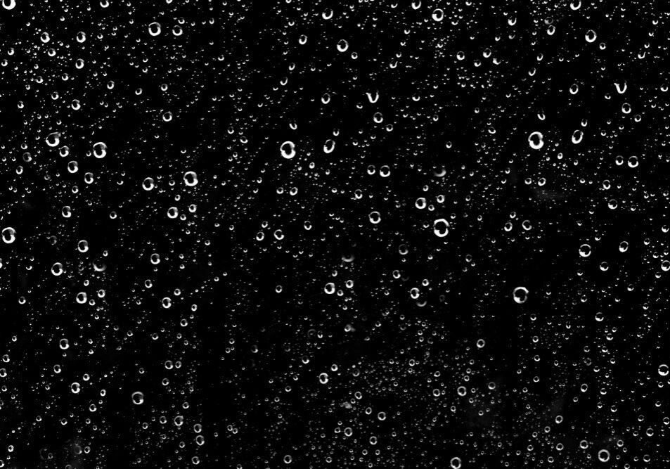 hundreds-of-white-rain-drops-on-a-glass-window-picture-id907865252